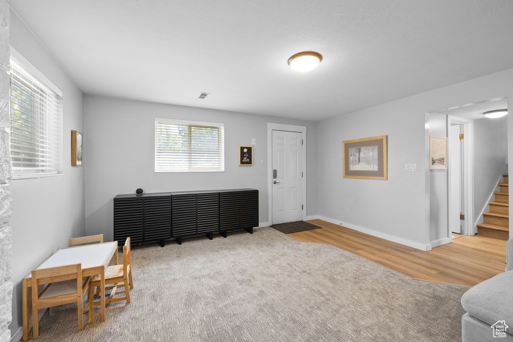 Foyer entrance featuring wood finished floors and stairs