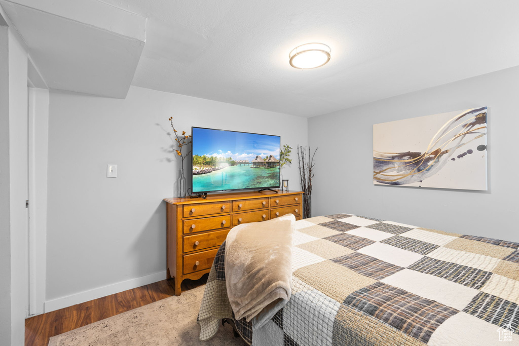 Bedroom featuring wood finished floors and baseboards
