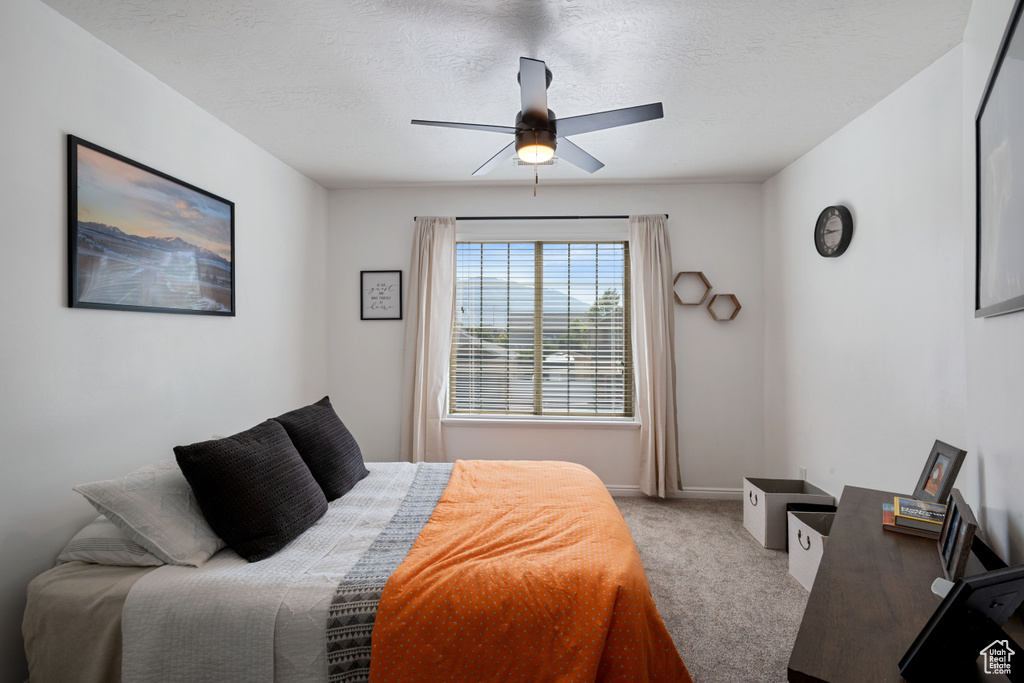Carpeted bedroom with baseboards and ceiling fan