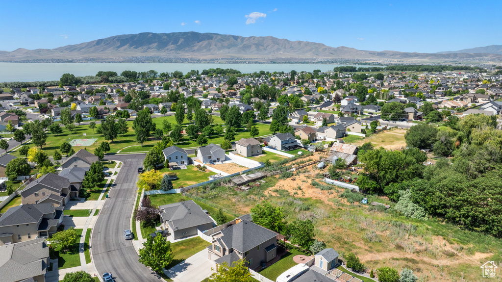 Aerial view of property\'s location featuring a water and mountain view and nearby suburban area