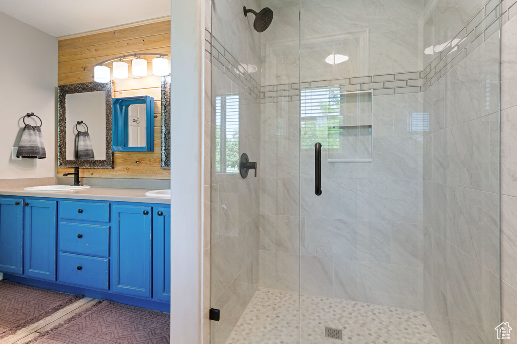 Full bathroom featuring a stall shower and double vanity