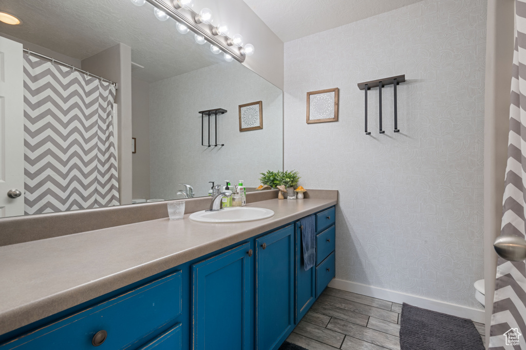 Bathroom featuring vanity and wood tiled floors