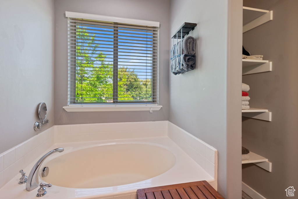 Full bath featuring plenty of natural light and a garden tub