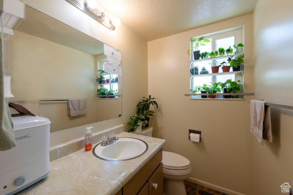 Bathroom with vanity and a textured ceiling