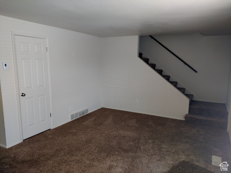Below grade area with carpet flooring and stairway