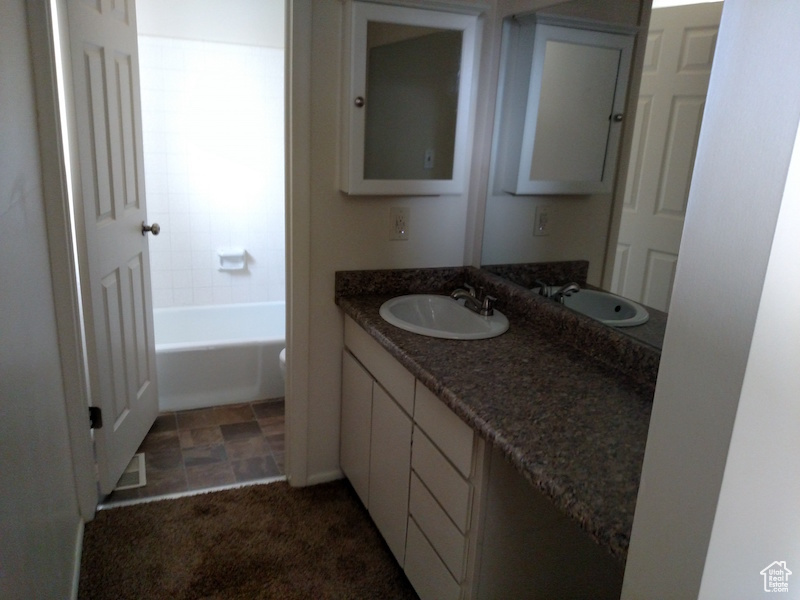 Full bathroom with vanity and a tub