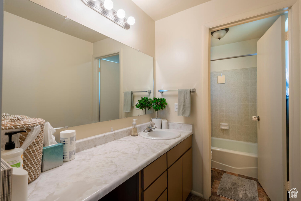 Bathroom with vanity and  shower combination