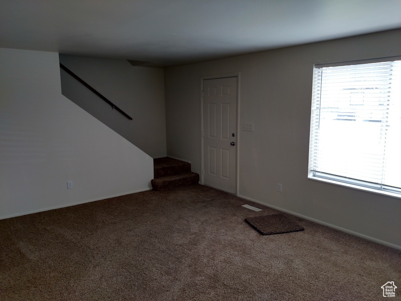 Entrance foyer featuring carpet flooring and stairway