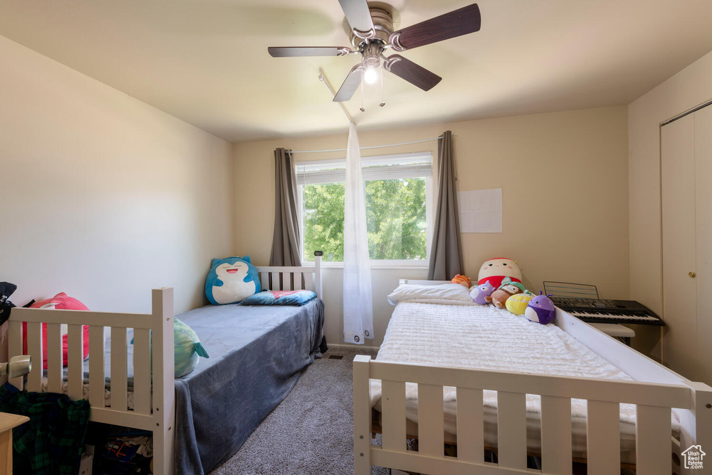 Bedroom with carpet and a ceiling fan