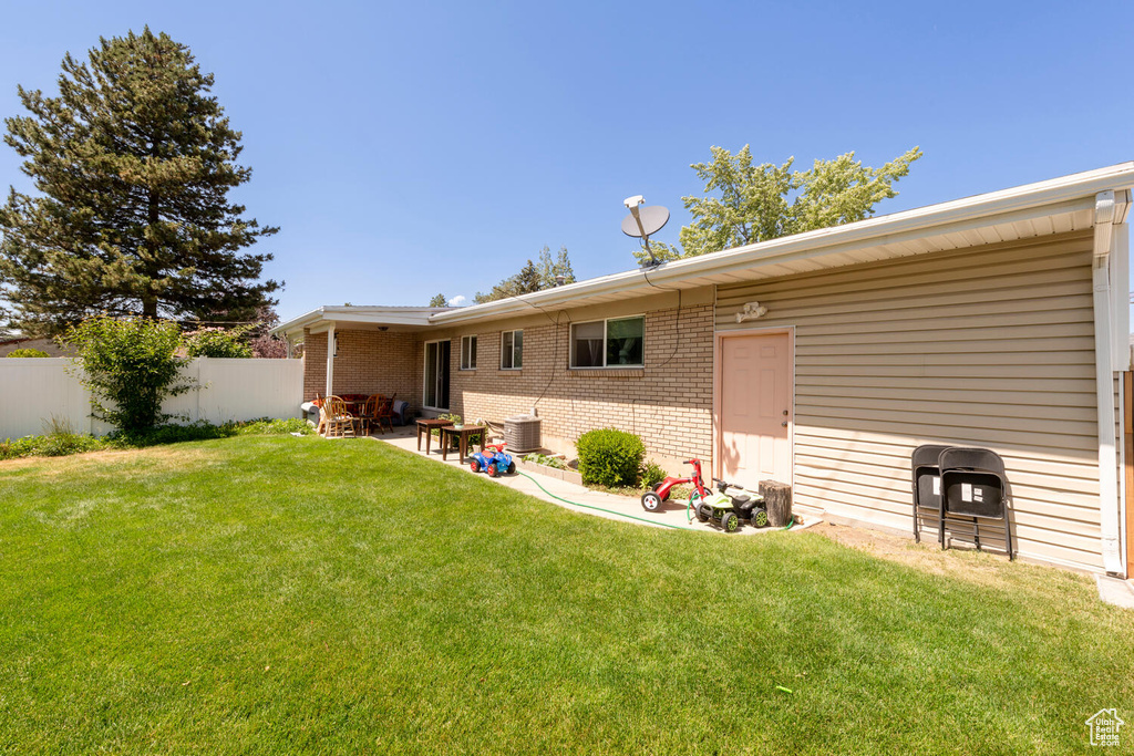 Back of house with brick siding and a patio