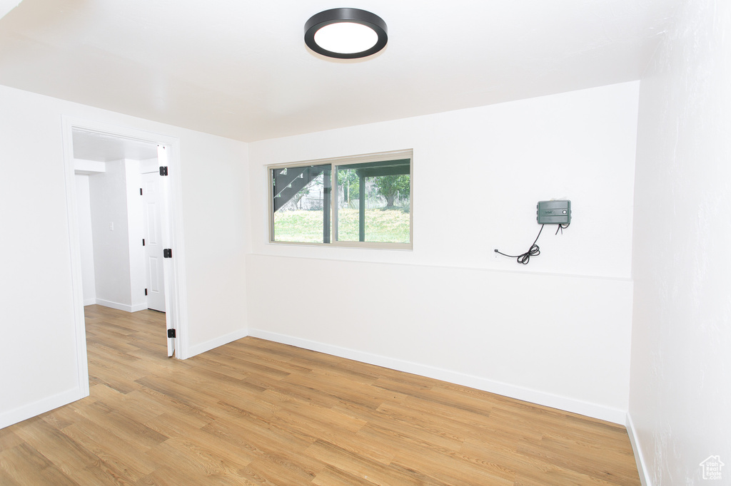 Spare room with light wood-type flooring and baseboards