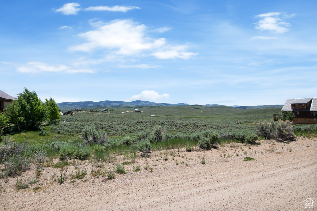 View of mountain backdrop with rural landscape
