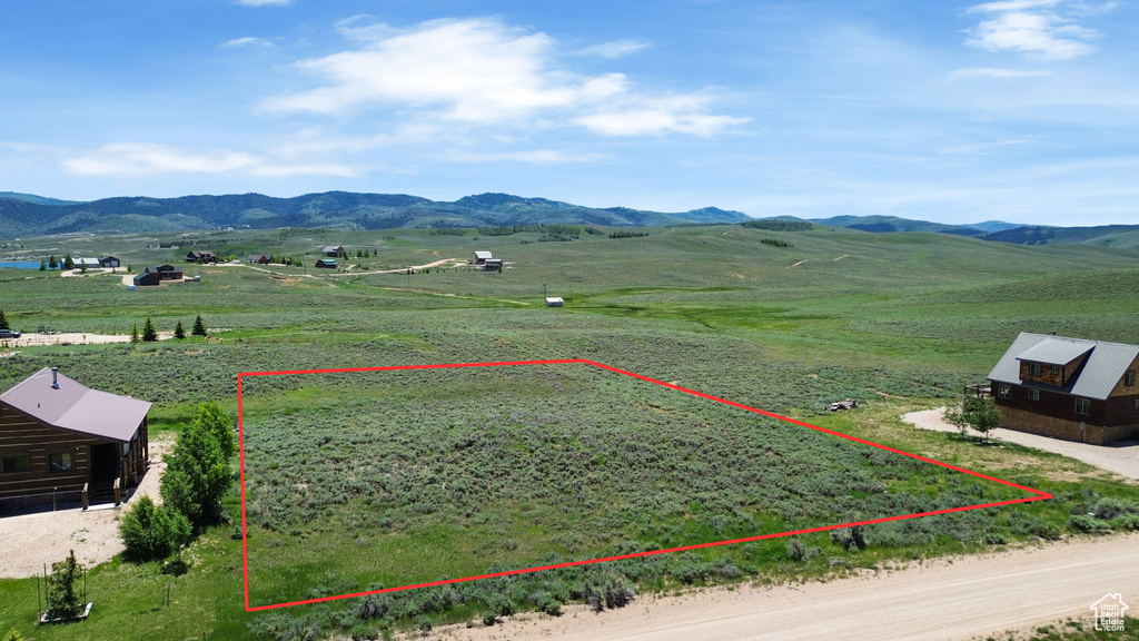 View of rural area featuring a mountain backdrop and property parcel outlined