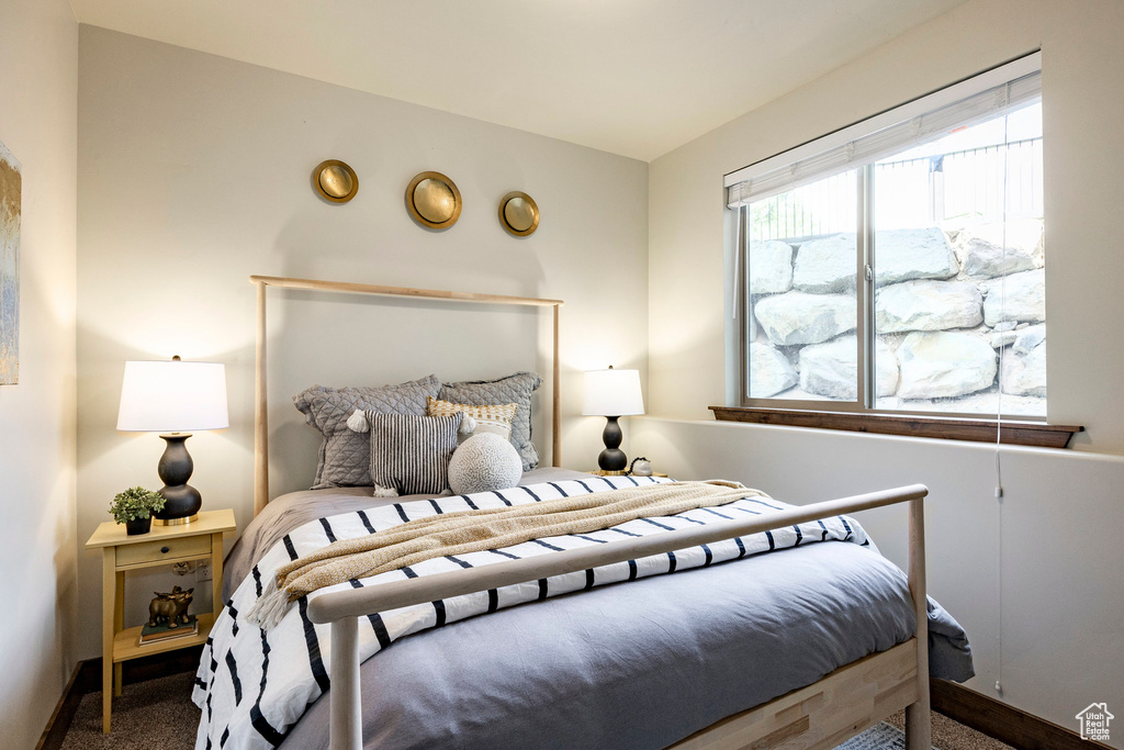 Carpeted bedroom featuring baseboards