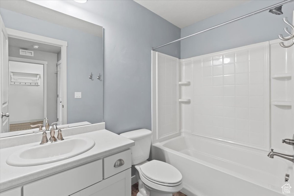 Full bath featuring vanity and bathing tub / shower combination