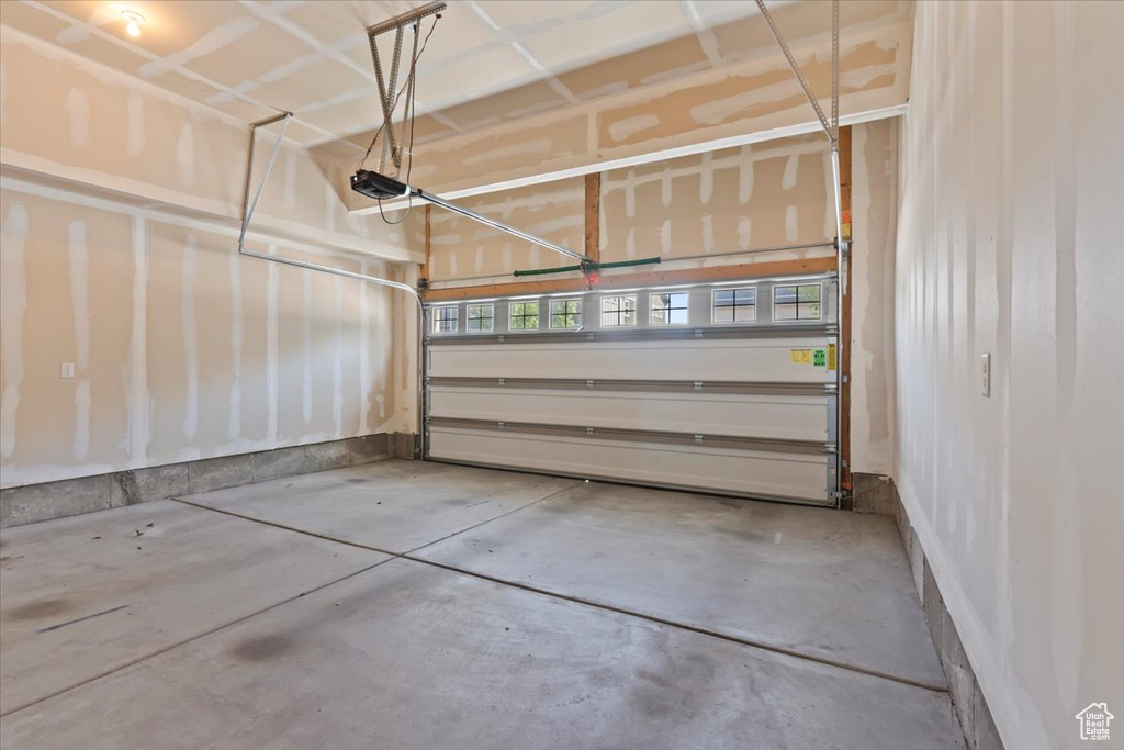 Garage featuring a garage door opener