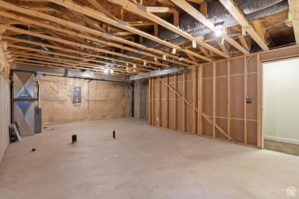 Unfinished basement featuring electric panel