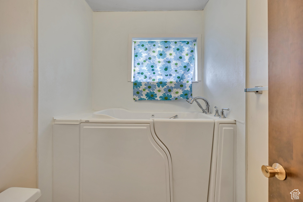 Bathroom with a garden tub and toilet