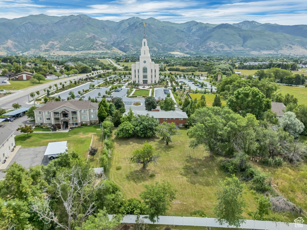 Aerial view of property and surrounding area featuring a mountainous background