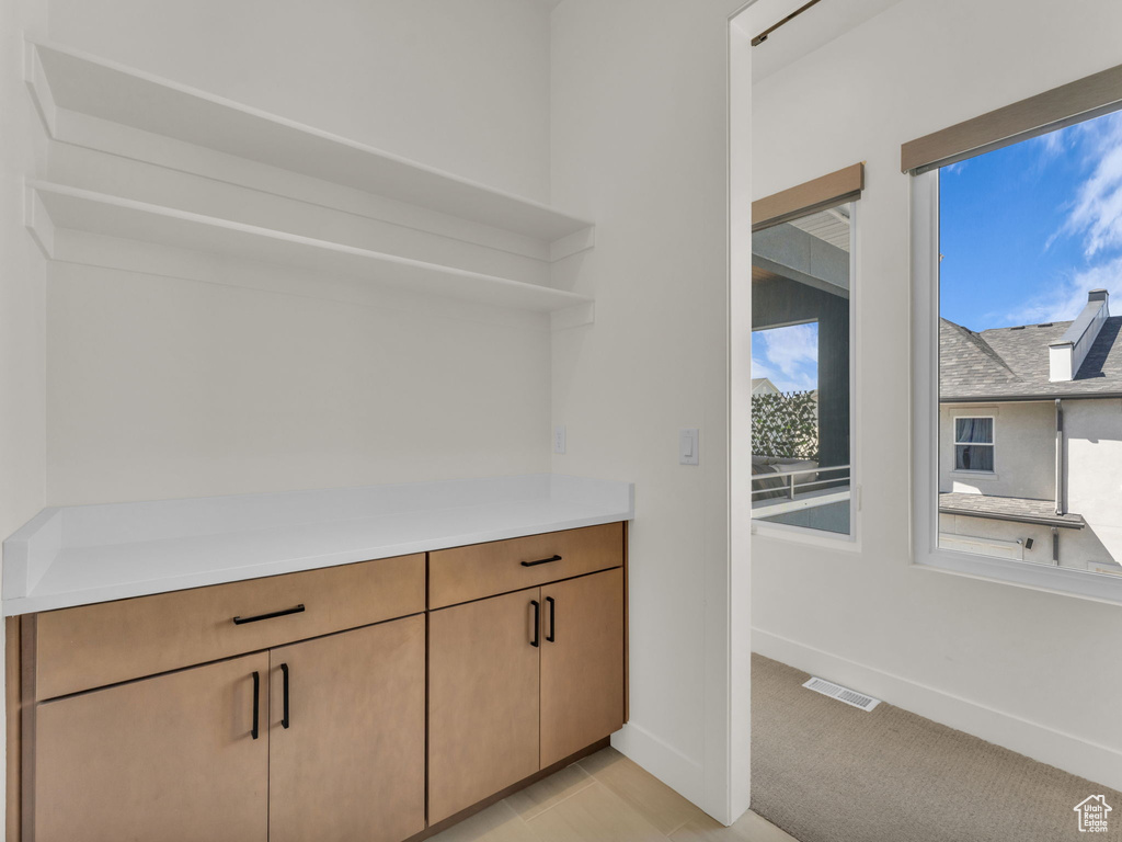 Bar with baseboards and light carpet