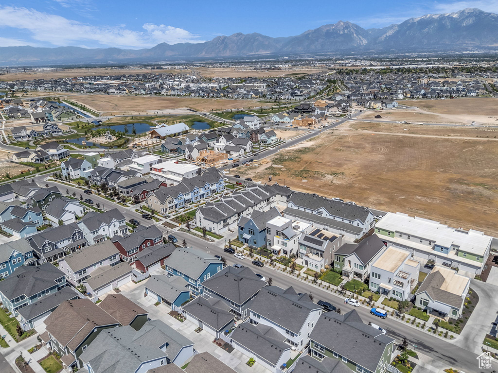 Aerial view of property's location with a water and mountain view and nearby suburban area