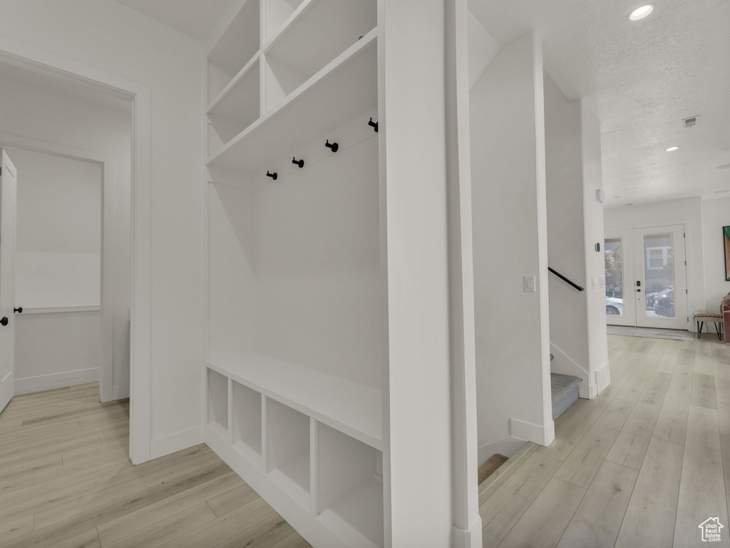 Mudroom featuring light wood-type flooring, recessed lighting, and french doors