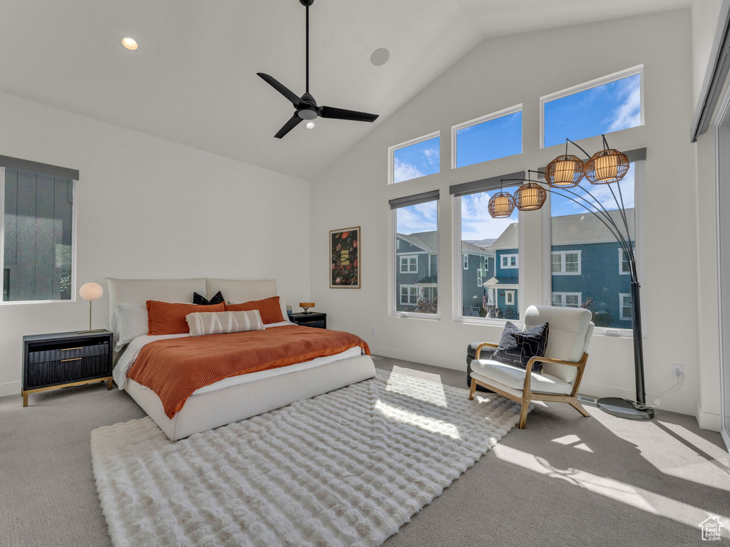Carpeted bedroom with high vaulted ceiling, recessed lighting, and a ceiling fan