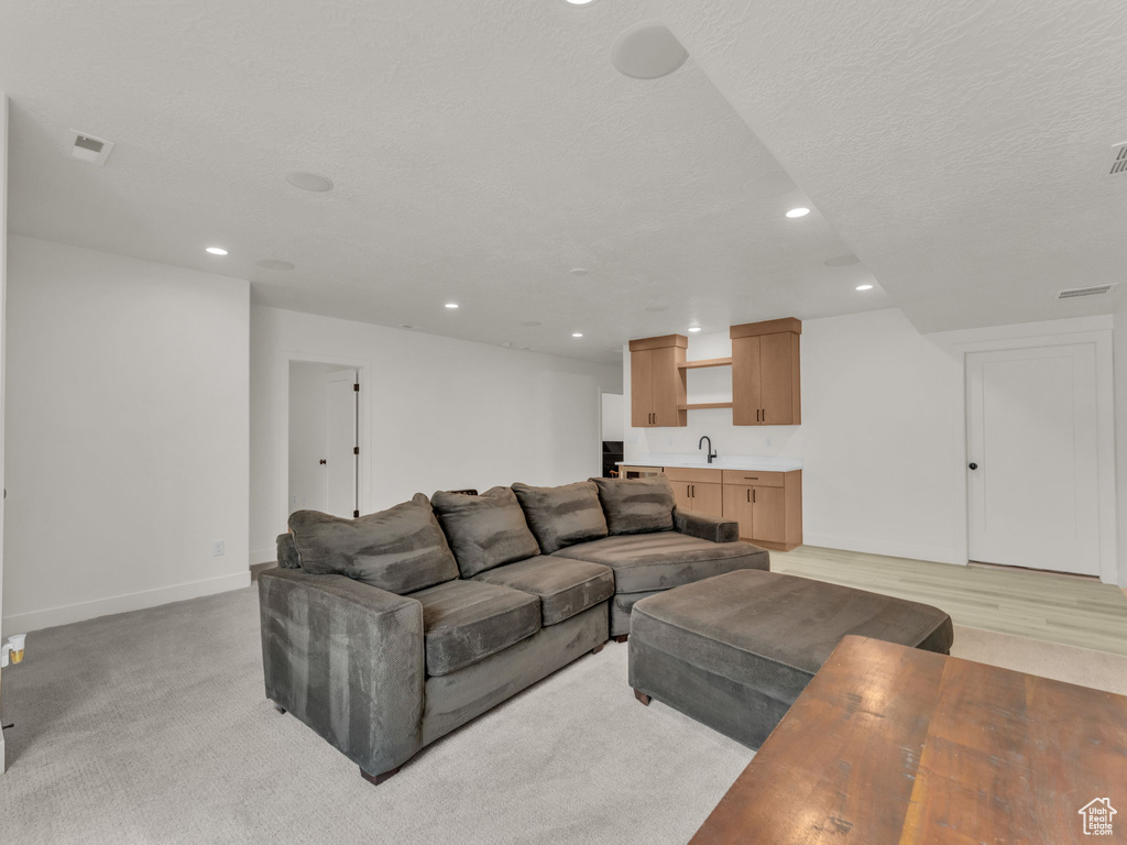 Living area featuring recessed lighting and light carpet