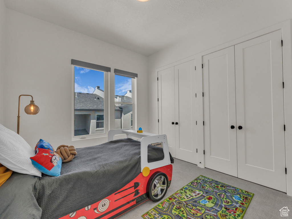Carpeted bedroom with multiple closets