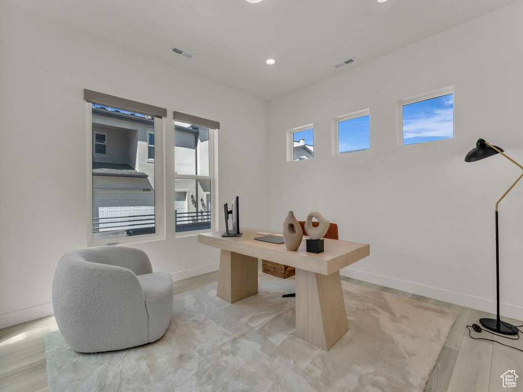 Office space with recessed lighting and baseboards