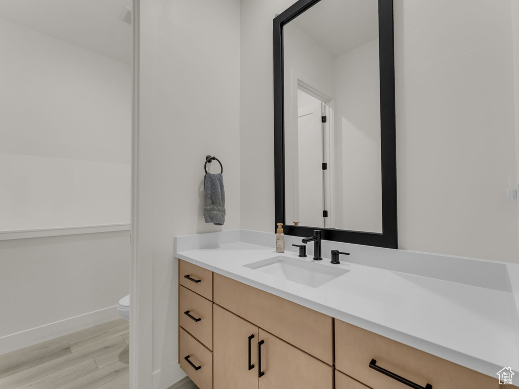 Bathroom with vanity and wood finished floors