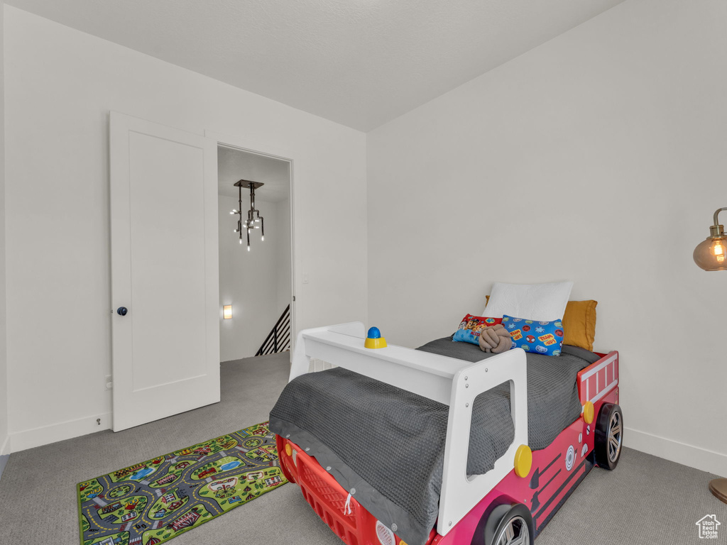Carpeted bedroom featuring baseboards