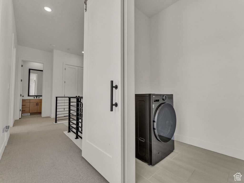Laundry area with washer / clothes dryer and recessed lighting