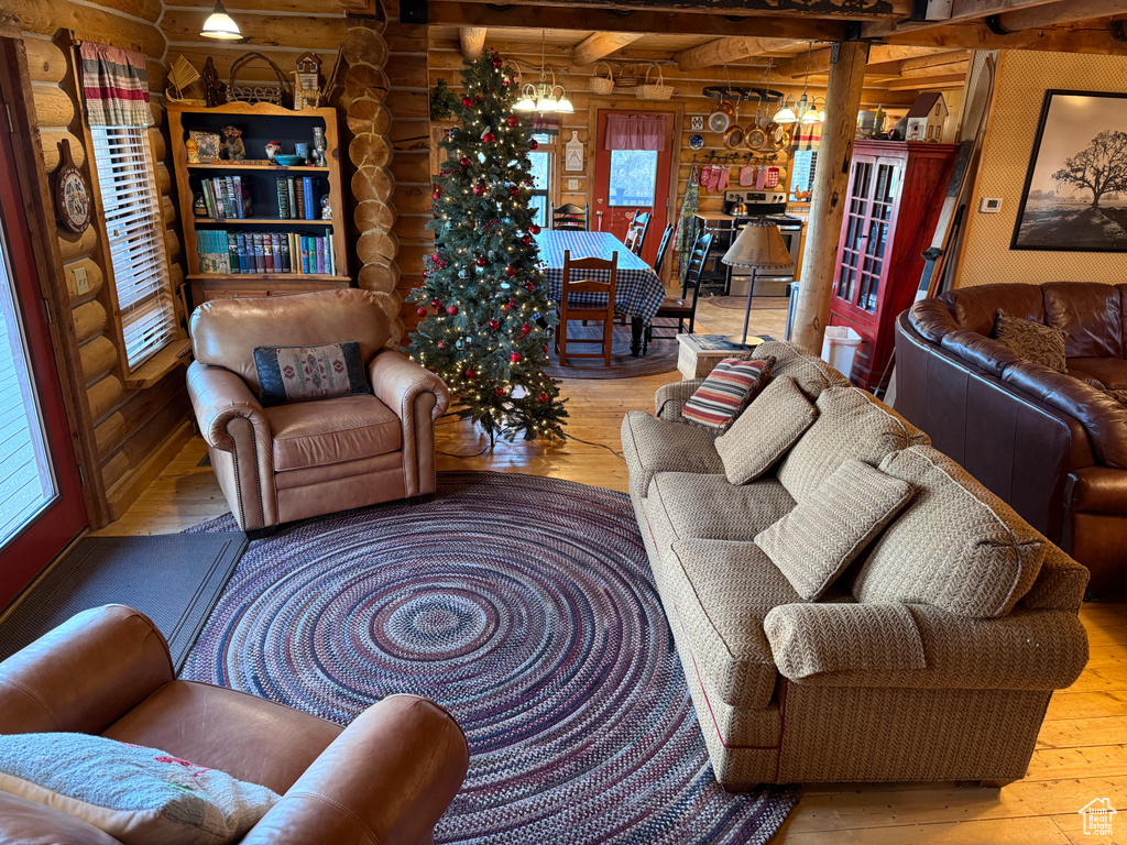 Living room featuring rustic walls, hardwood / wood-style floors, and healthy amount of natural light