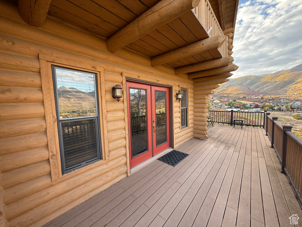 Wooden deck with a mountain view and french doors