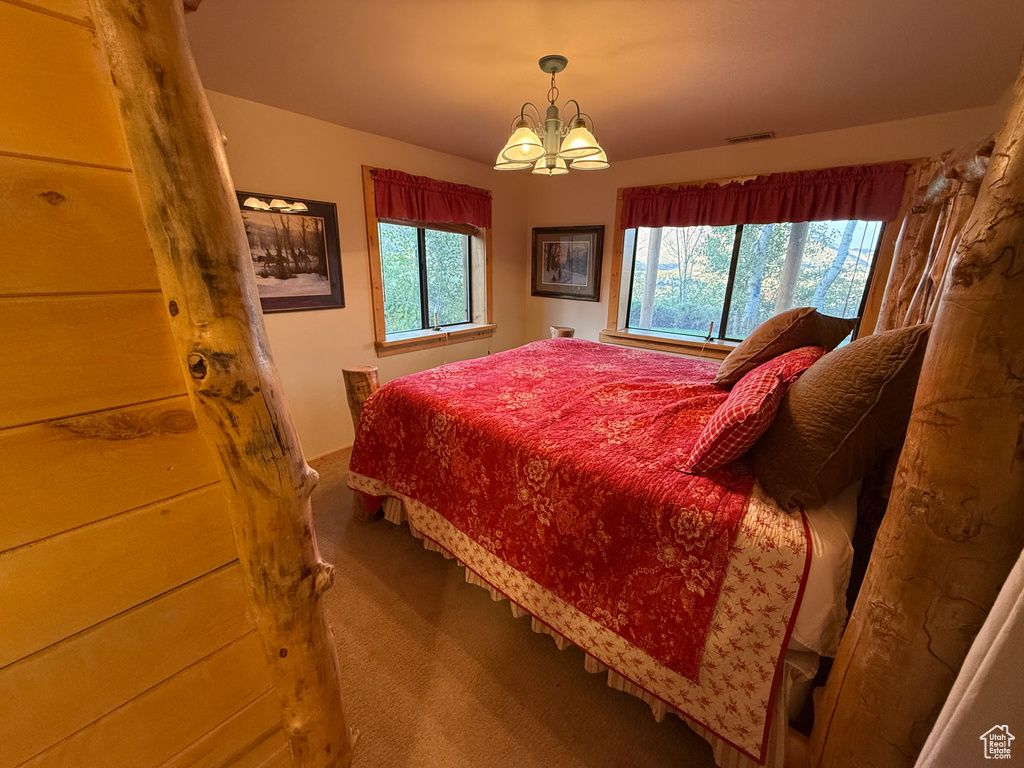 Carpeted bedroom with a chandelier