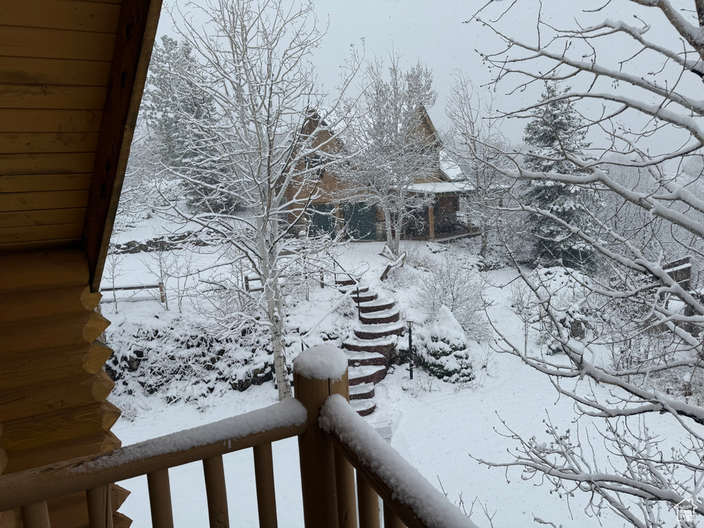 Snowy yard with a balcony