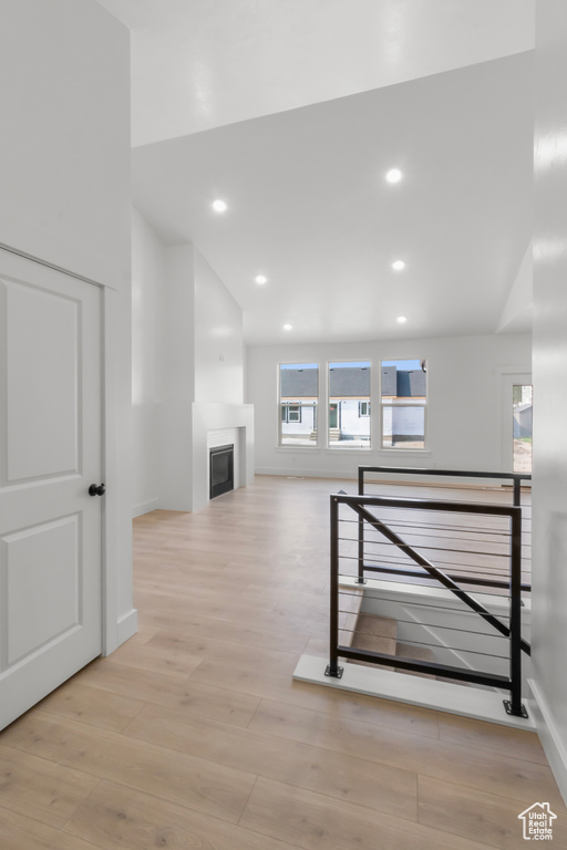Hall featuring light wood-type flooring and recessed lighting