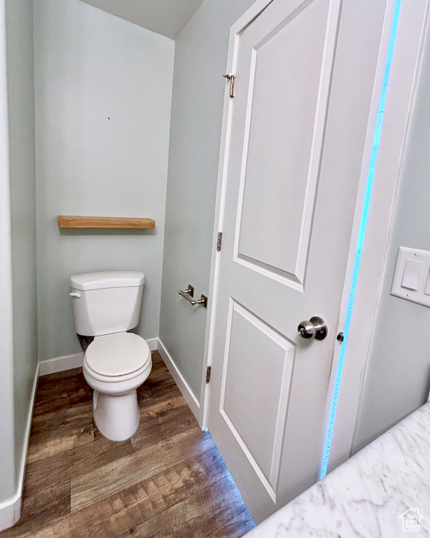 Bathroom featuring wood finished floors and toilet