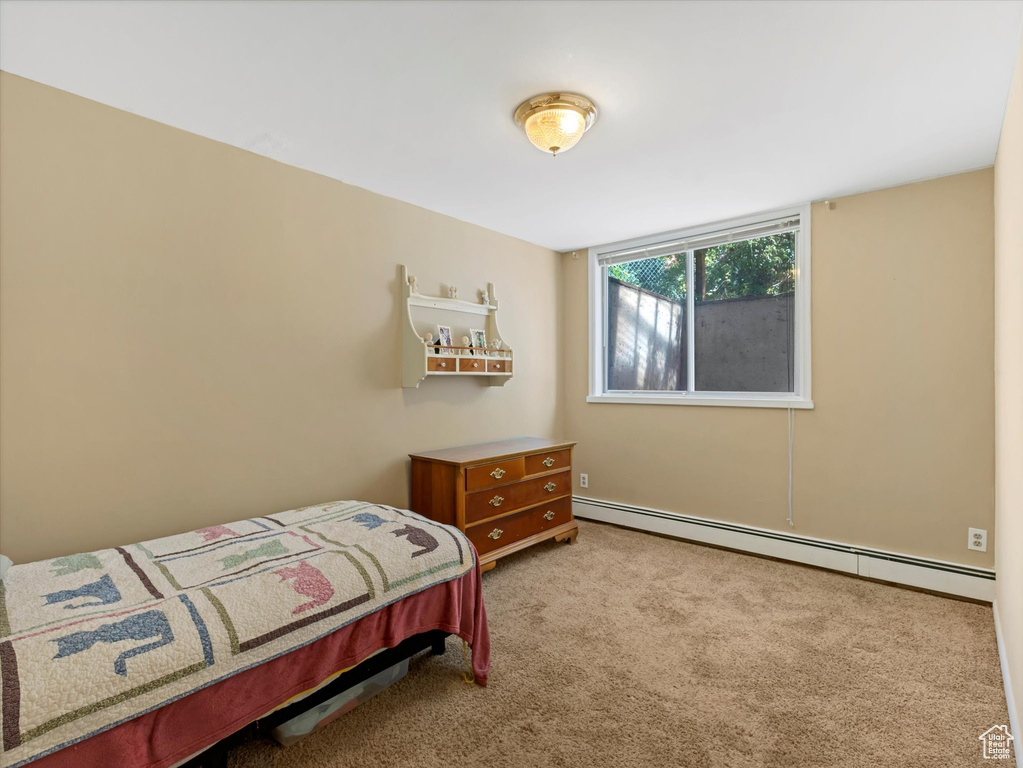 Bedroom featuring baseboard heating and carpet floors