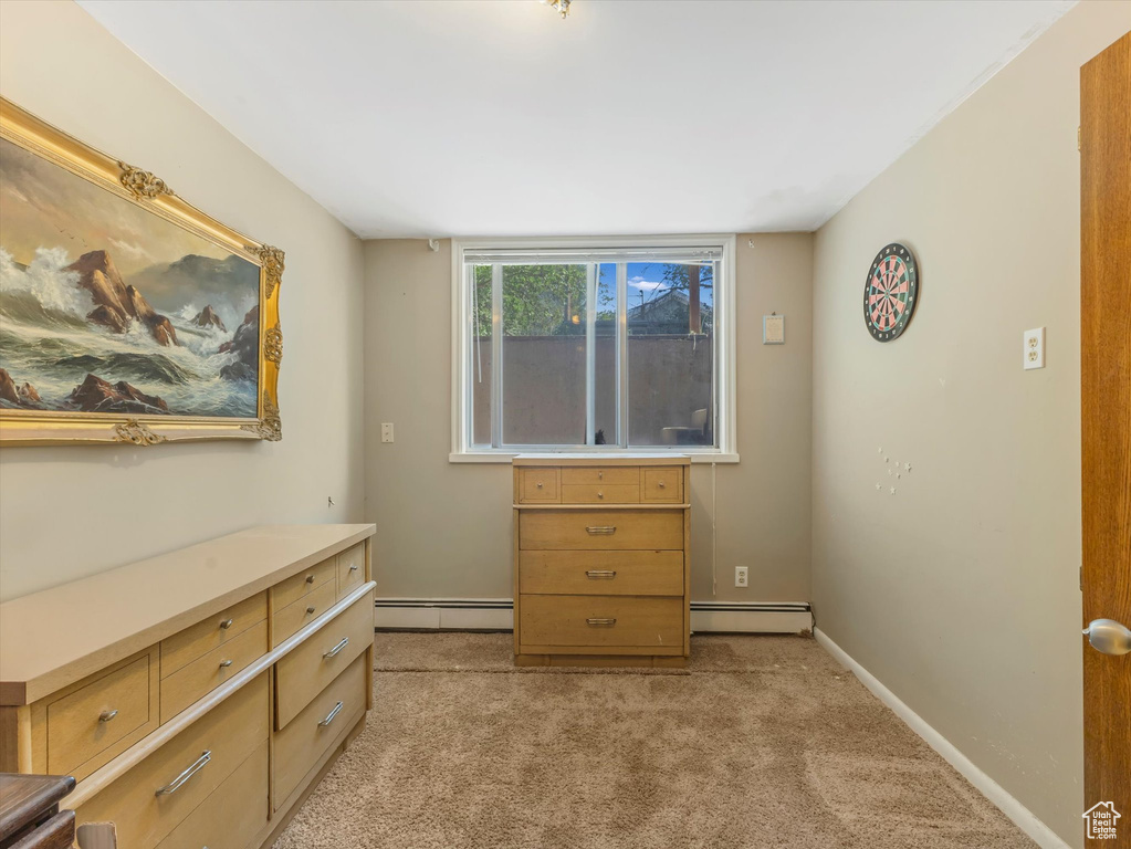 Bedroom featuring baseboard heating and light colored carpet