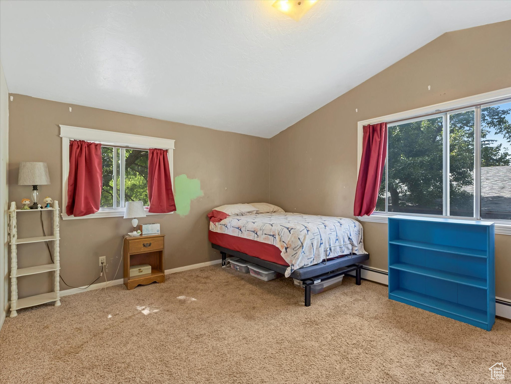 Bedroom with carpet, lofted ceiling, and baseboard heating