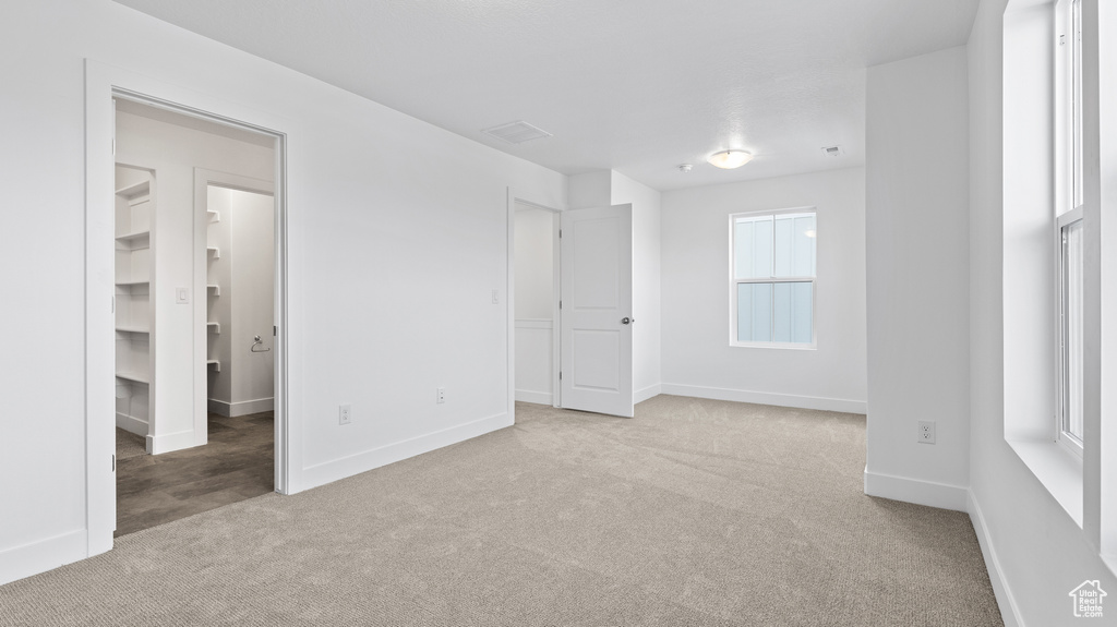Carpeted empty room with baseboards