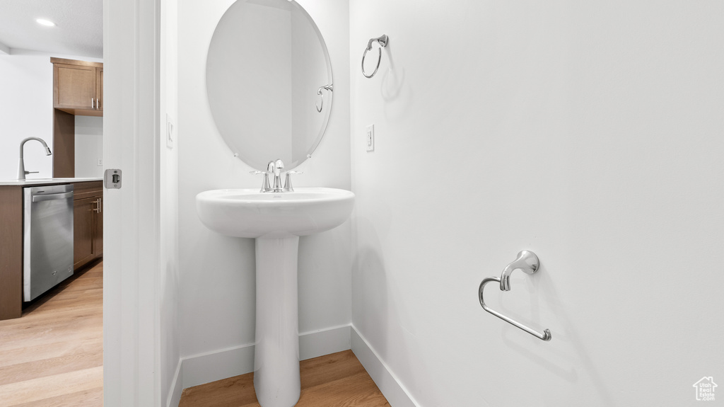 Bathroom with wood finished floors and baseboards
