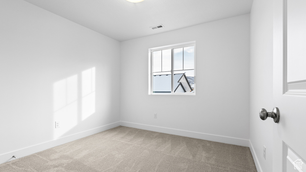 Unfurnished room featuring carpet floors and baseboards