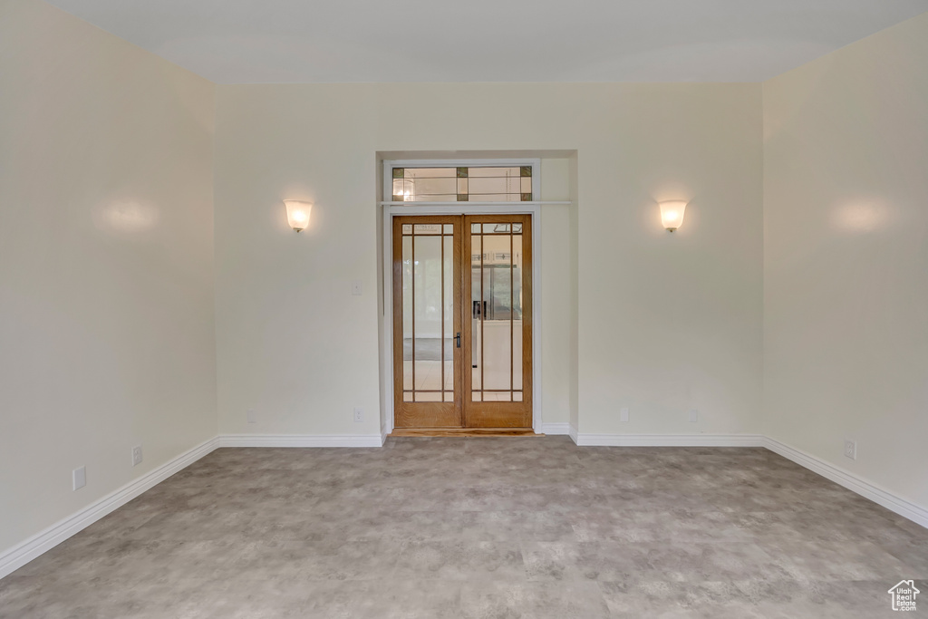 Unfurnished room featuring carpet and baseboards
