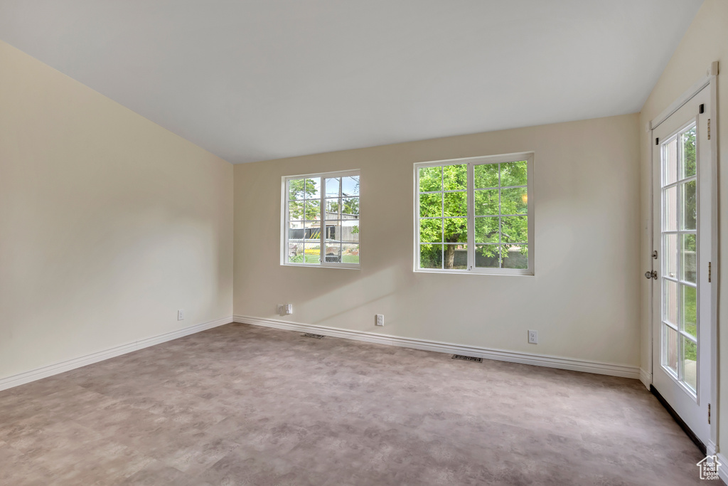 Carpeted empty room with healthy amount of natural light
