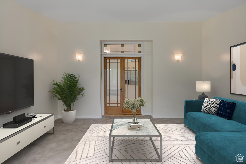 Living room with light colored carpet and baseboards