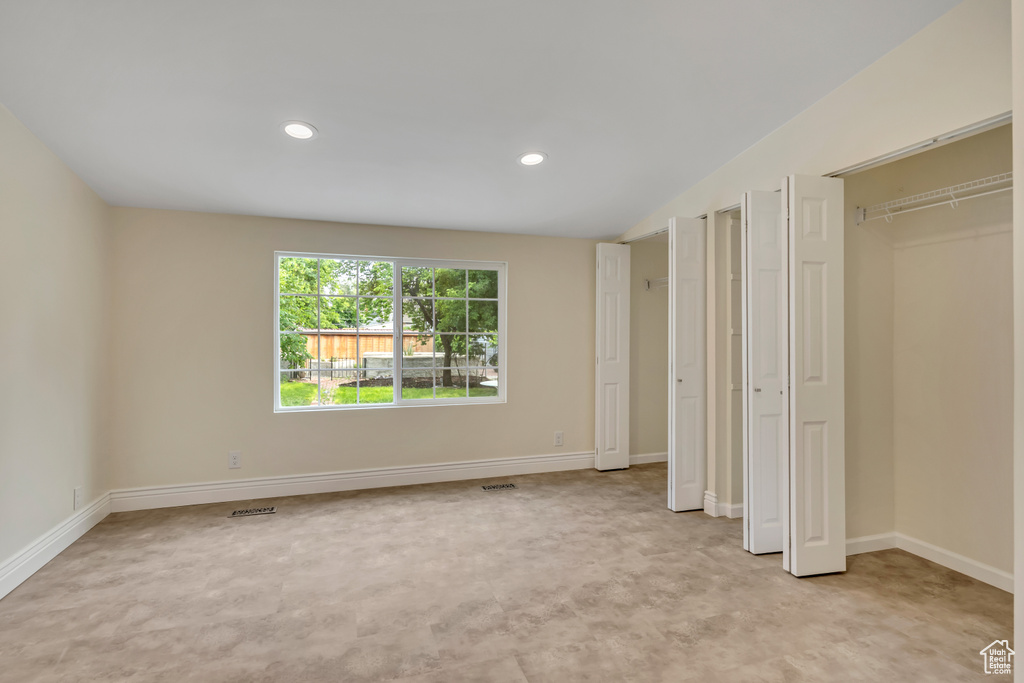Unfurnished bedroom with recessed lighting and light colored carpet