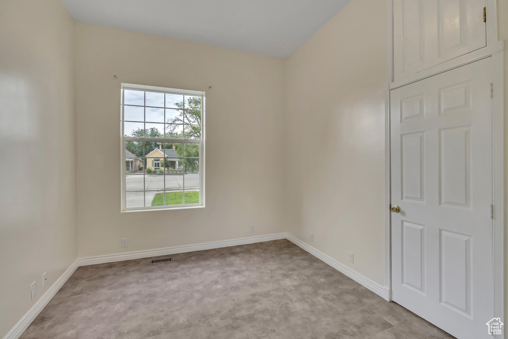 Spare room featuring baseboards and light colored carpet